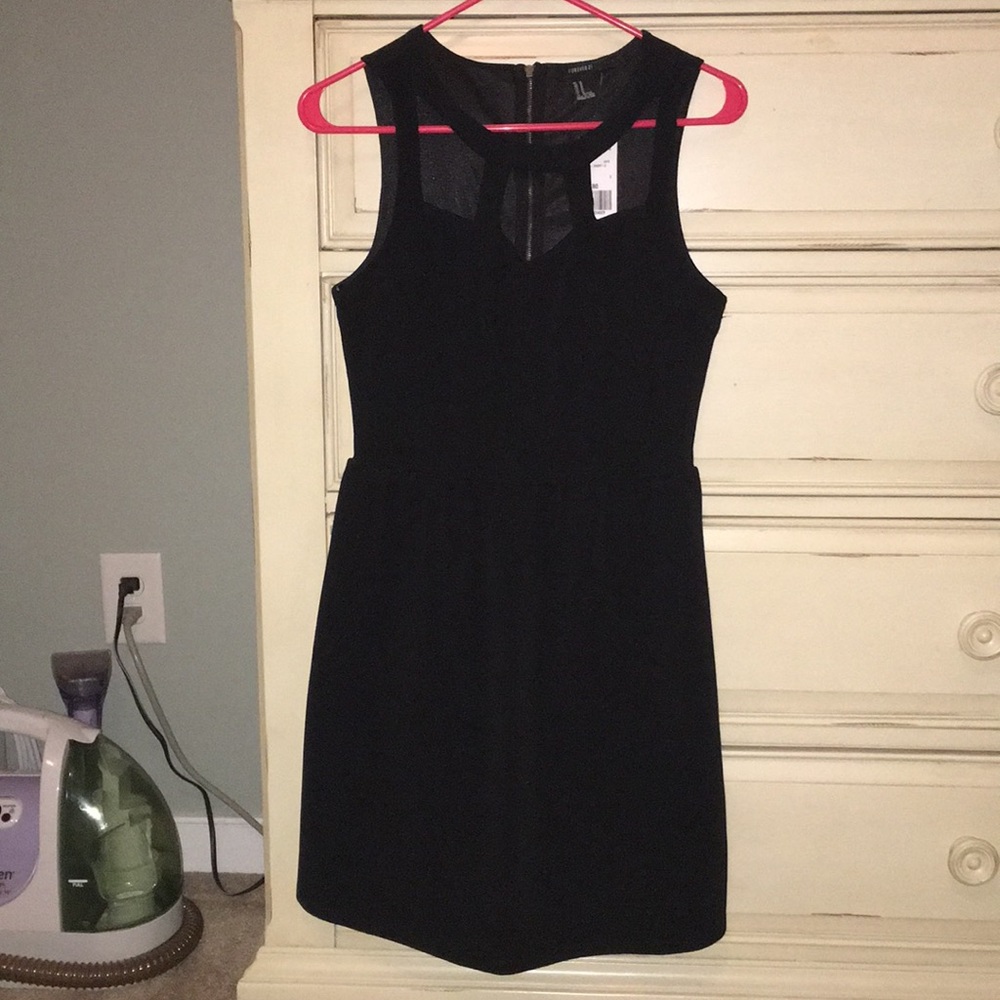 Black dress with cut out top. Gold zipper (back)